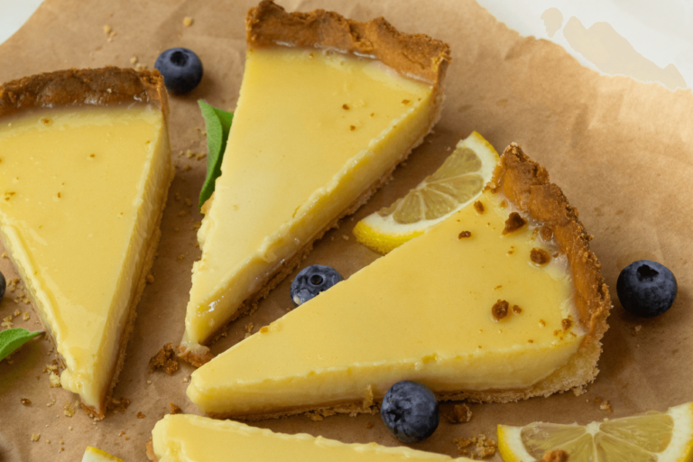 A beautifully baked French lemon tart with a golden, flaky crust and a smooth, tangy lemon filling, garnished with powdered sugar and fresh lemon slices. Select 68 more words to run Humanizer.
